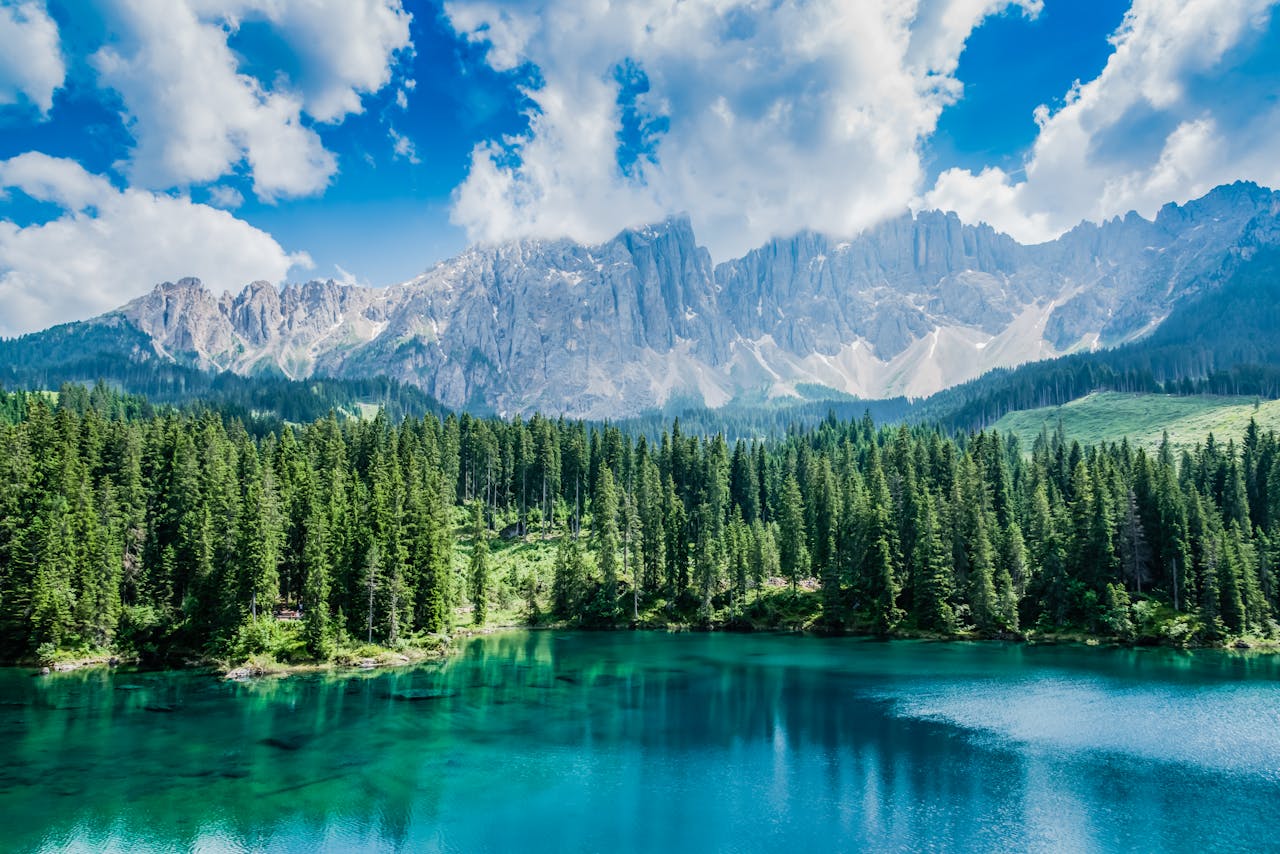 Breathtaking view of Lake Carezza with the Dolomites in the background, showcasing nature's beauty in Italy.